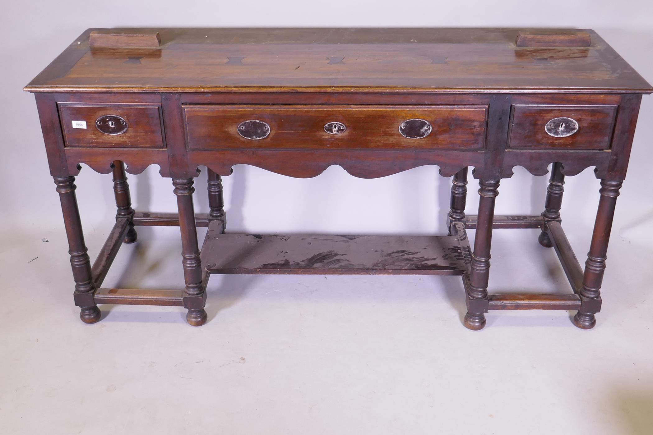 A South African hardwood Georgian style dresser base, with three drawers and shaped apron, raised on - Image 2 of 5
