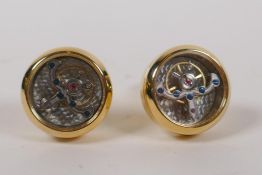 A pair of gilt metal cufflinks containing clock movements