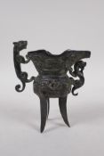 A Chinese bronze Jue (wine vessel), with kylin handle and dragon decoration, 13cm high