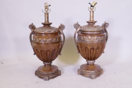 A pair of urn shaped carved wood table lamps with parcel gilt decoration, 65cm high