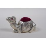 A silver plated pin cushion in the form of a camel, 6cm long