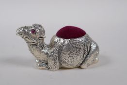 A silver plated pin cushion in the form of a camel, 6cm long