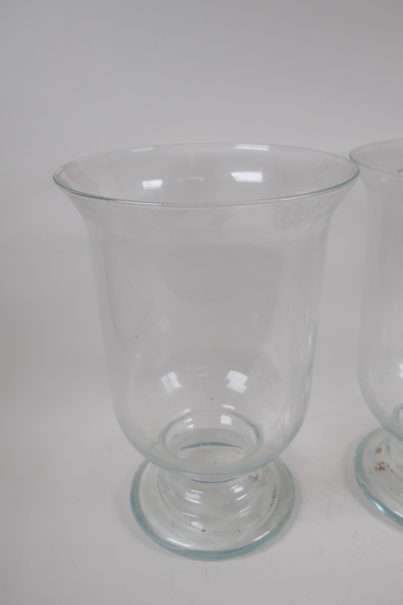 A pair of blown glass hurricane vases on pedestal feet, 39cm high, 27cm diameter - Image 3 of 4