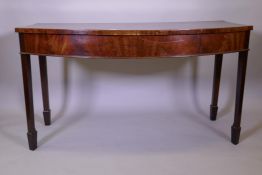 A C19th mahogany 'D' shaped serving table, raised on square tapering supports terminating in spade