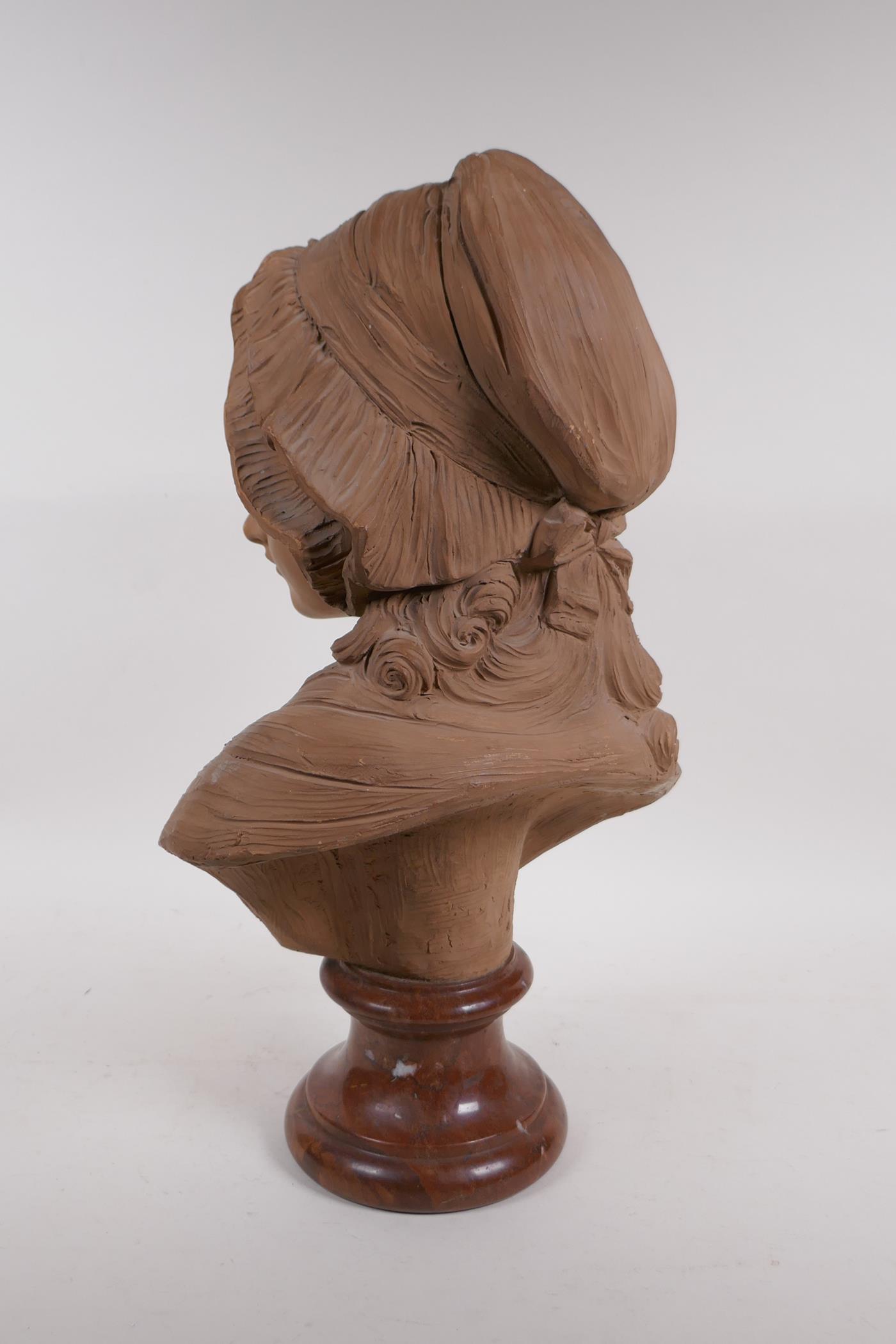 A C19th terracotta bust of a young girl in a bonnet, mounted on a marble socle, 46cm high - Image 3 of 4