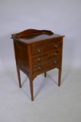 A mahogany three drawer music cabinet with a three quarter gallery and square tapering supports,