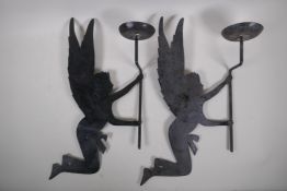 A pair of iron wall sconces in the form of fairies, 25cm x 50cm