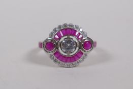 An Art Deco style silver dress ring set with cubic zirconia and rubies, size O