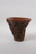 A Chinese faux horn libation cup decorated with figures and birds in a landscape, impressed mark