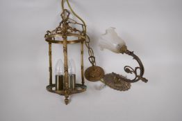 A cylindrical brass hall lantern, 38cm long, AF glass missing, and a cast brass wall sconce with