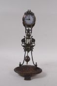 A bronzed metal mystery clock with a trinket dish base, 28cm high