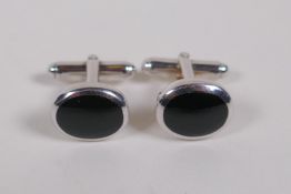A pair of silver and black agate set cufflinks