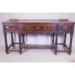 A South African hardwood Georgian style dresser base, with three drawers and shaped apron, raised on