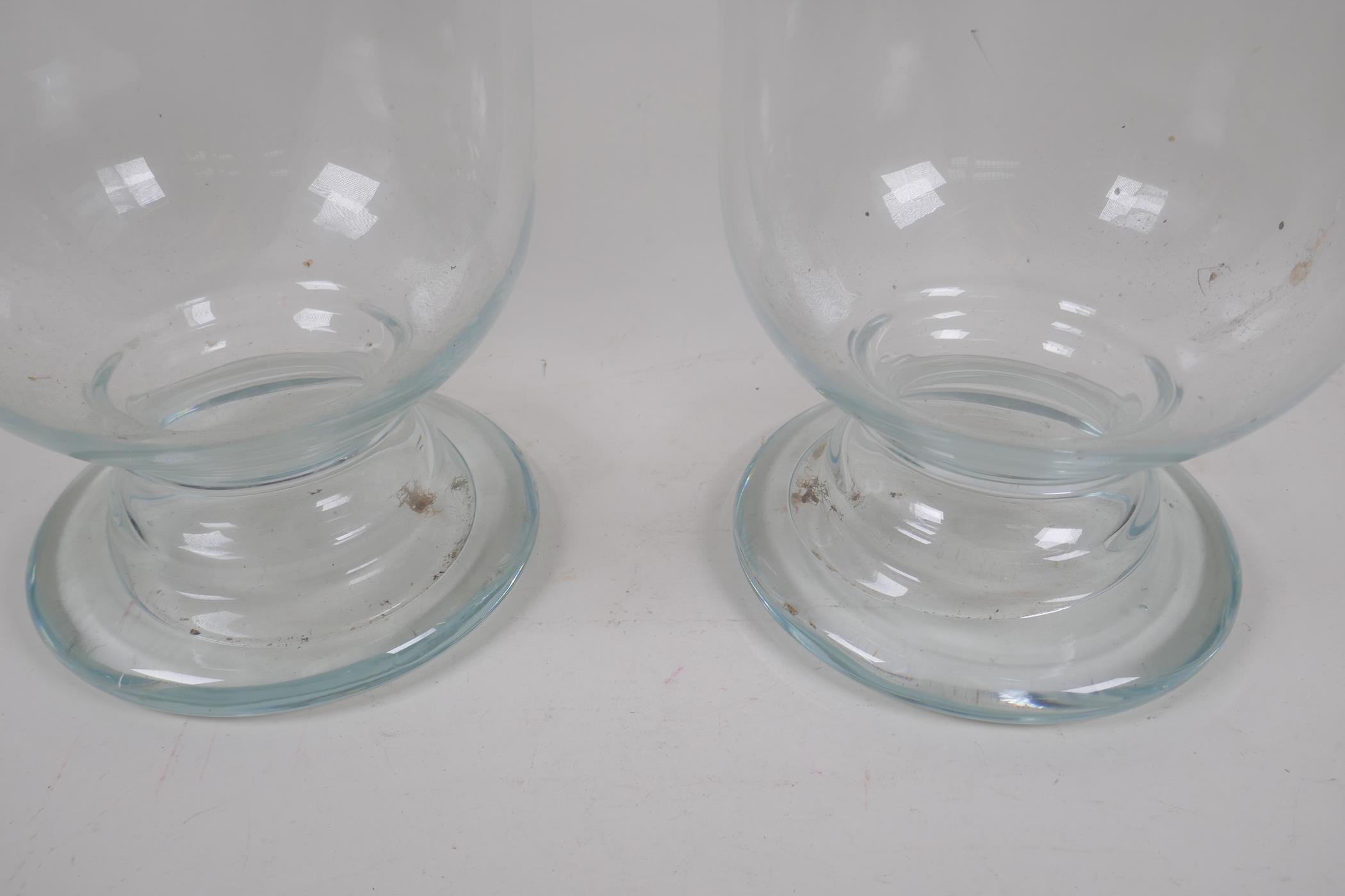 A pair of blown glass hurricane vases on pedestal feet, 39cm high, 27cm diameter - Image 4 of 4