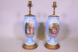 A pair of C19th American blue glazed porcelain lamps with cartouches decorated with children at