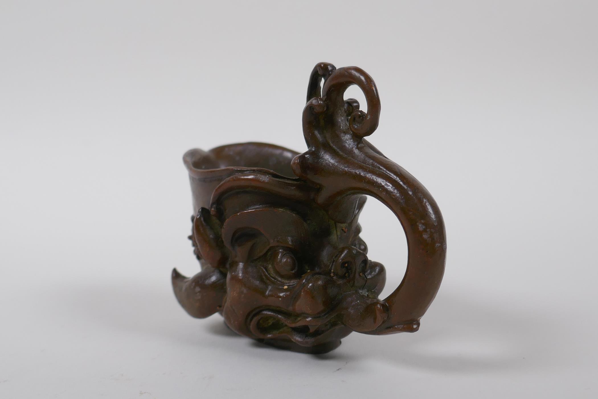 A Chinese bronze libation cup with dragon head decoration, 8 cm high - Image 2 of 4