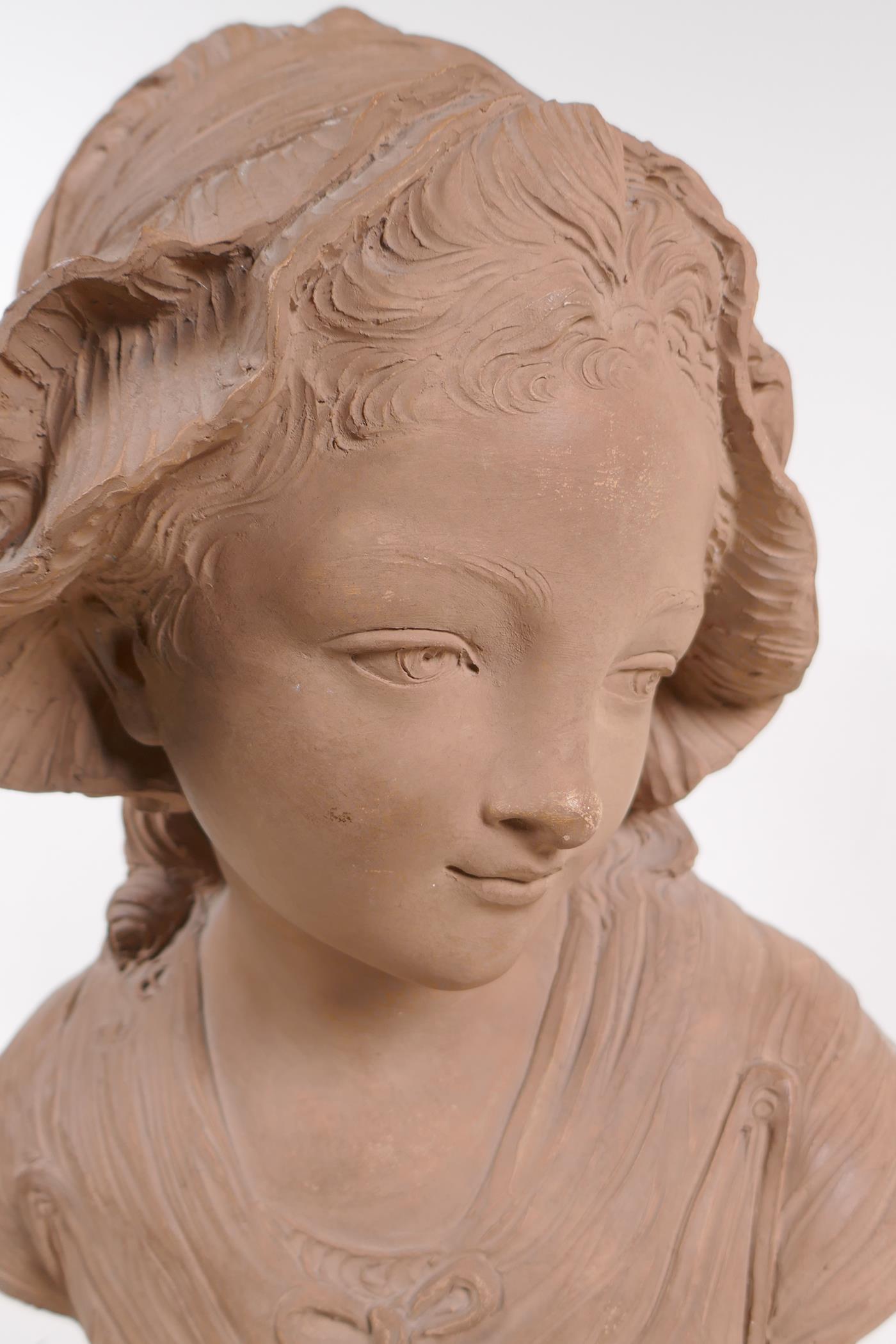 A C19th terracotta bust of a young girl in a bonnet, mounted on a marble socle, 46cm high - Image 2 of 4