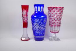 An overlaid and flash cut ruby glass stem vase with star cut bases, 35cm high and a Bohemian blue