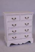 A painted mahogany chest of two over three drawers, with brass swan neck handles, raised on shaped