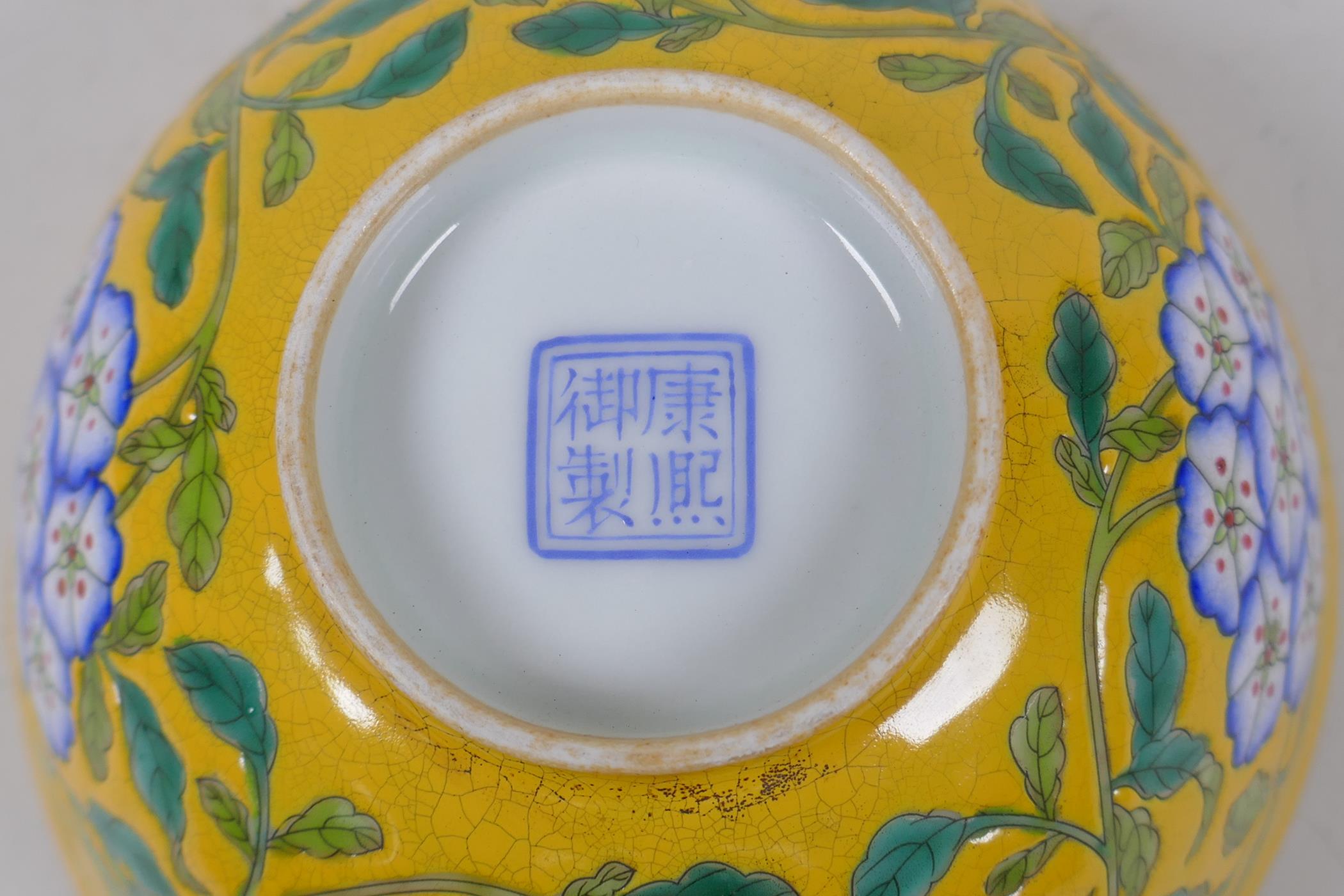 A polychrome porcelain rice bowl with enamelled floral decoration on a yellow ground, Chinese KangXi - Image 4 of 4