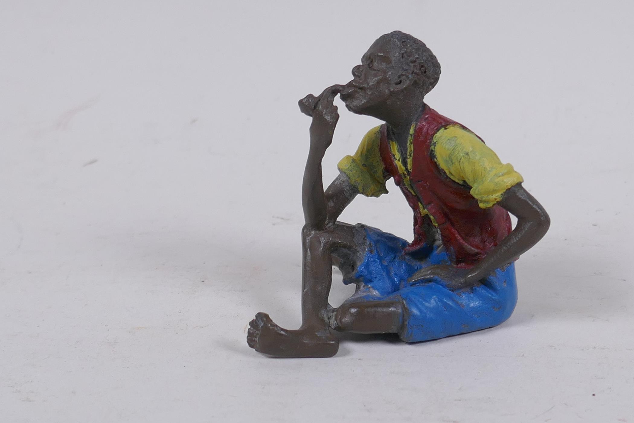 A Bergmann style cold painted bronze figure of a man smoking a pipe, 6cm high