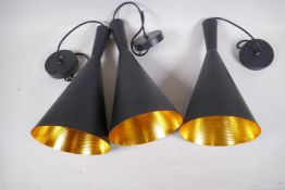 Three black and gilt studio lamps, 39cm high