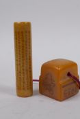 A Chinese cylinder soapstone seal with a character inscription to the side, and another soapstone