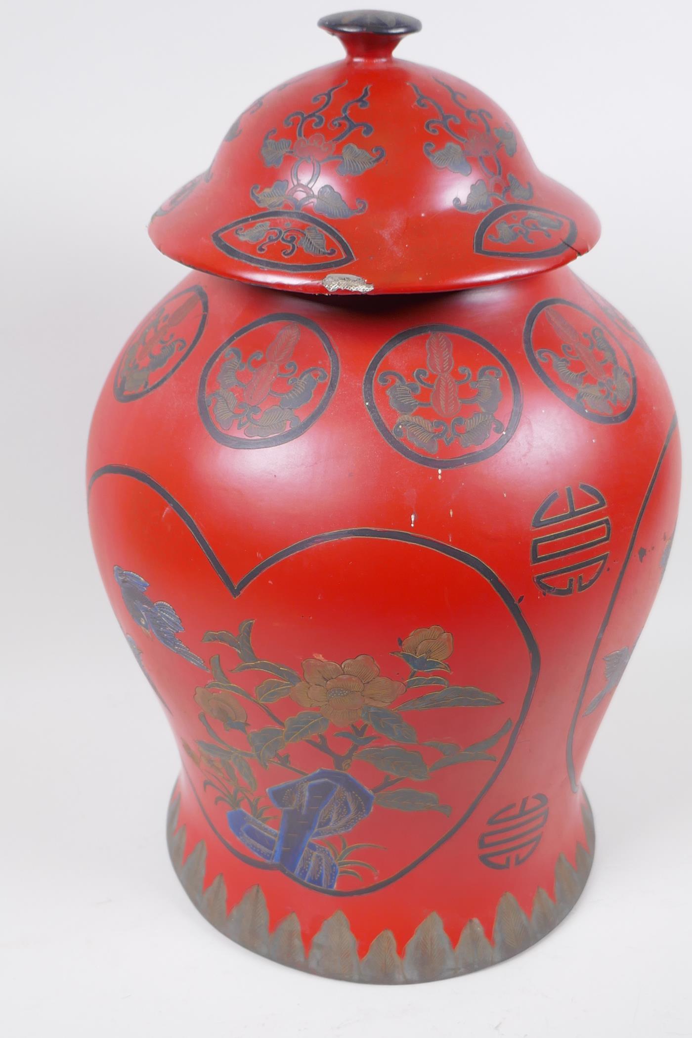 A Chinese lacquered jar and cover decorated with birds amongst flowering trees, and symbols, 41cm