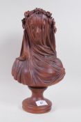 A glazed terracotta bust of a woman in a veil, 35cm high
