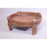 A South East Asian carved fruitwood low trough table, with metal straps, 80cm diameter x 29cm high