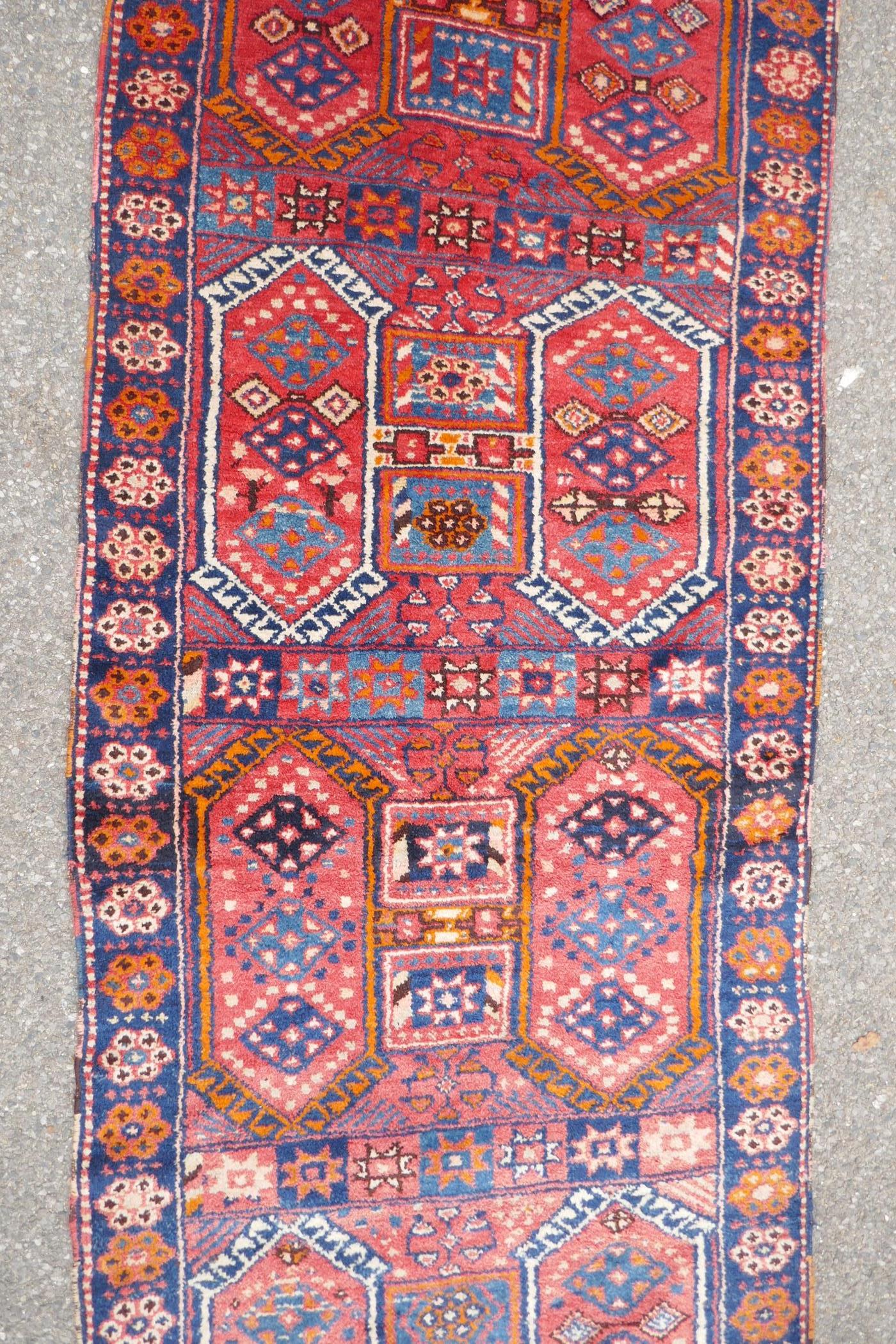 A Kurdish red ground full pile village rug/runner with unique geometric design, 290cm x 98cm - Image 4 of 7
