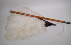 An ostrich feather fan with faux tortoiseshell blades, a malacca walking cane with oriental silver