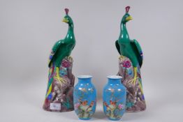 A pair of Chinese ceramic figures of peacocks, 35cm high, and a pair of blue glaze vases with floral