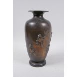 A Japanese Meiji bronze vase decorated with playful frogs, the back engraved with calligraphy,
