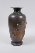 A Japanese Meiji bronze vase decorated with playful frogs, the back engraved with calligraphy,