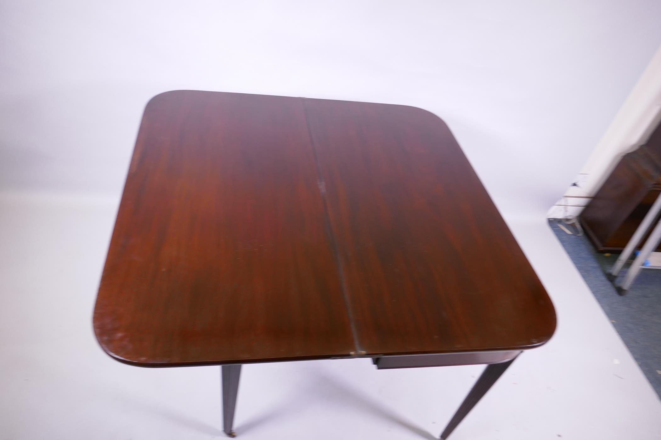 A Georgian mahogany D shaped tea table, raised on tapering reeded supports with brass castors, 102 x - Image 5 of 6