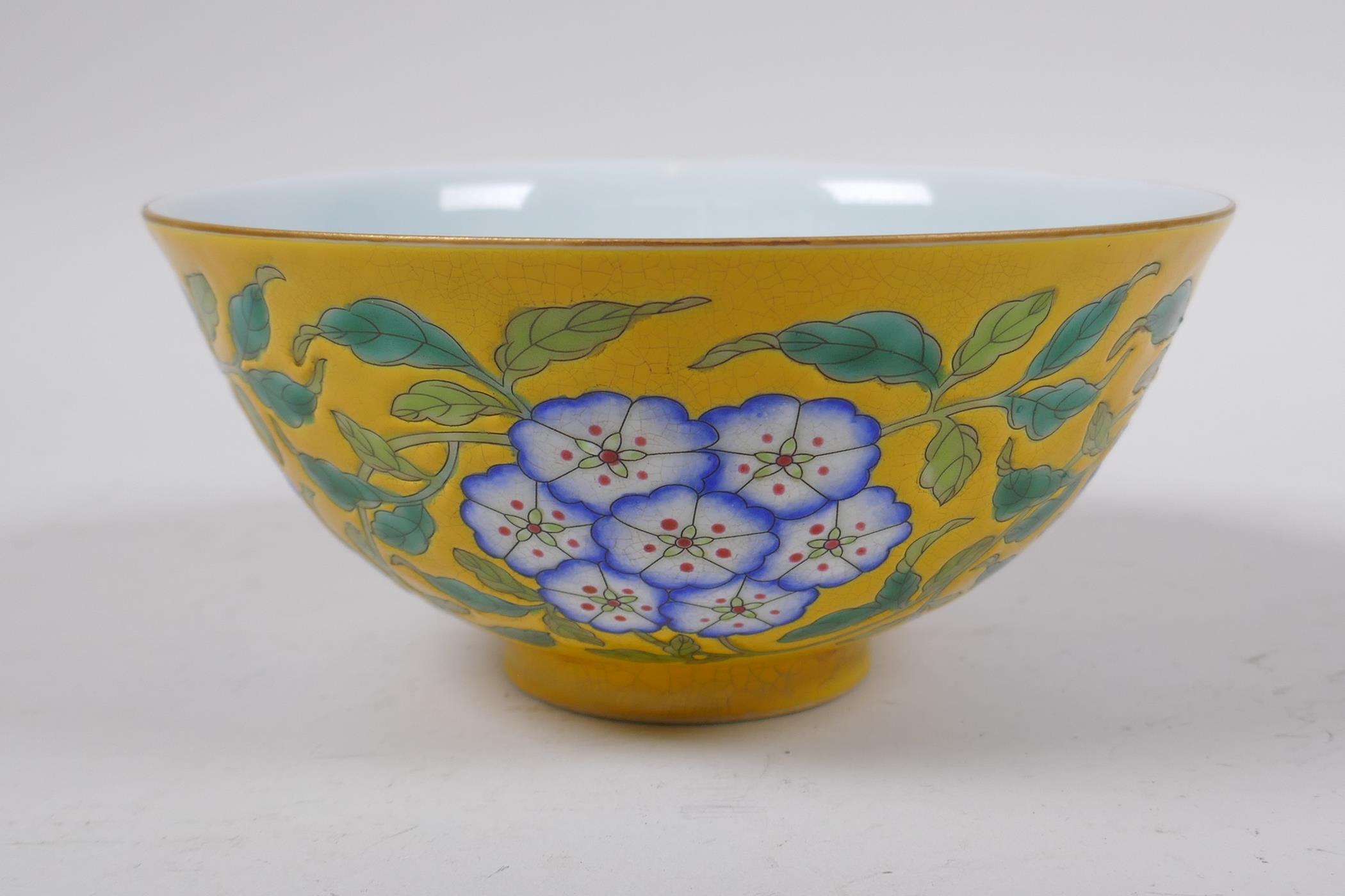 A polychrome porcelain rice bowl with enamelled floral decoration on a yellow ground, Chinese KangXi - Image 2 of 4