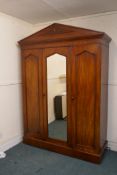 A Victorian mahogany mirrored door wardrobe, fitted with a hanging cupboard and four slide drawers