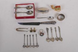 A collection of silver, silver plate and white metal items to include tea spoons, coin spoons,