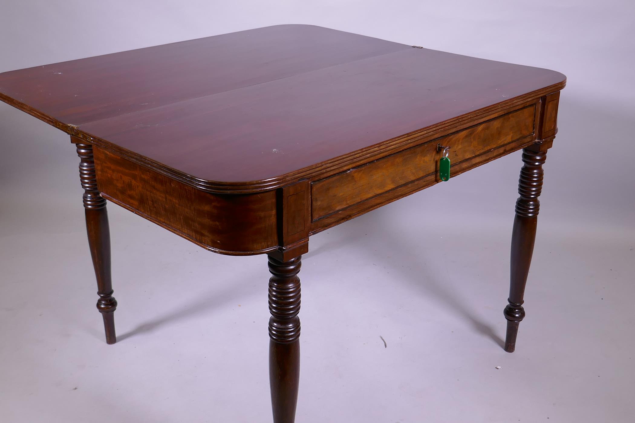 A Georgian mahogany D shaped dining table with reeded edge fold over top, raised on ring turned - Image 3 of 3