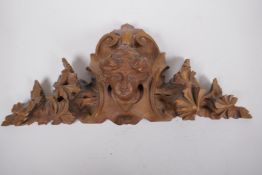 A carved walnut wall plaque, 48cm wide