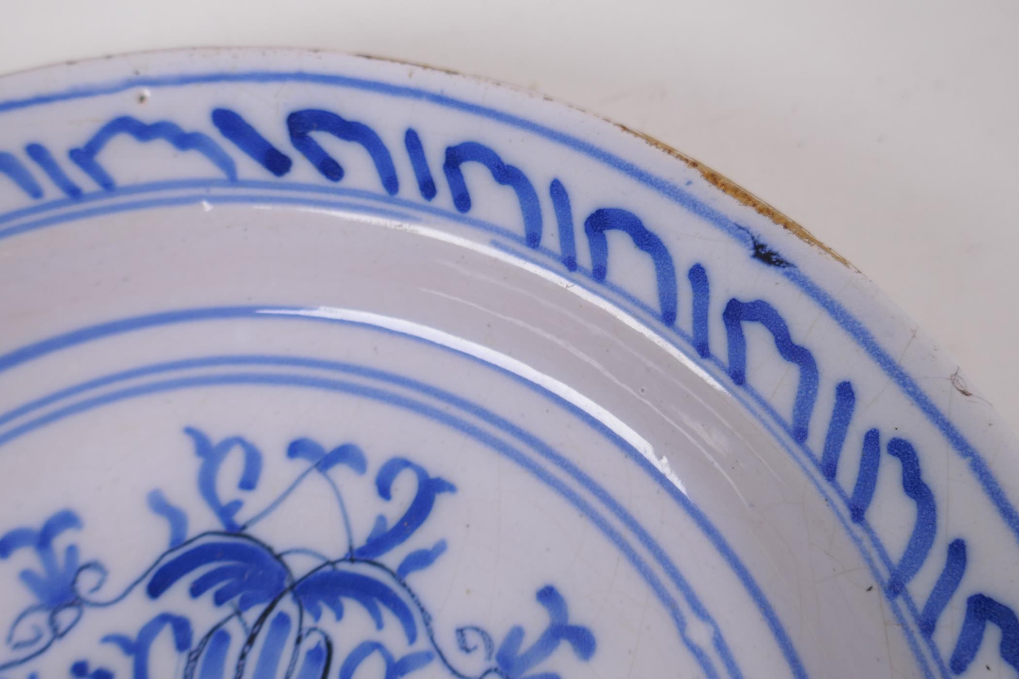 A late C18th/early C19th Delft tin glazed blue and white pottery bowl painted with flowers, 22cm - Image 3 of 4