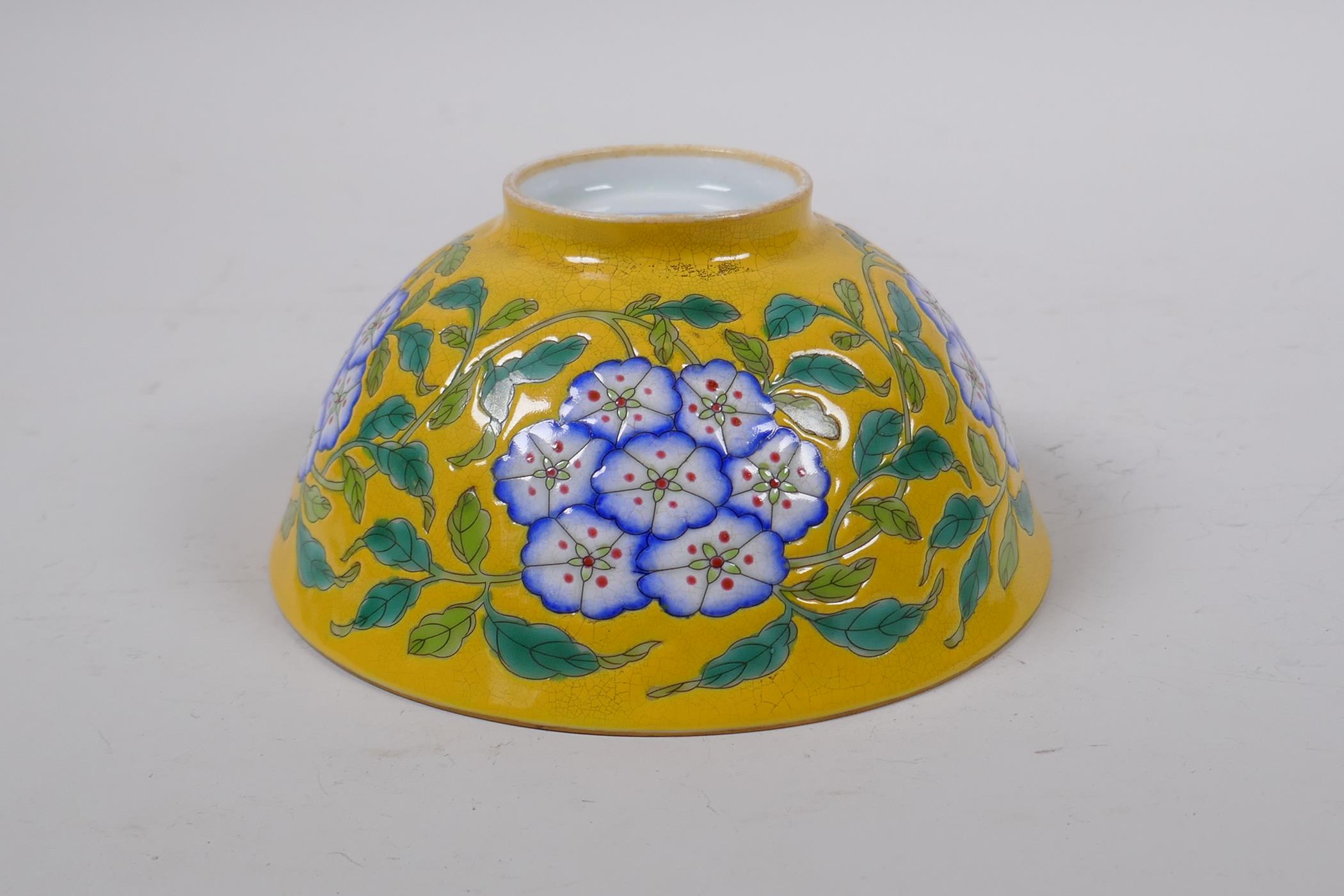 A polychrome porcelain rice bowl with enamelled floral decoration on a yellow ground, Chinese KangXi - Image 3 of 4