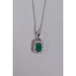 An 18ct white gold, emerald and diamond set pendant necklace, approx 40 points