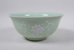 A celadon ground porcelain bowl with pat-sur-pat lotus flower decoration, Chinese Qianlong seal mark