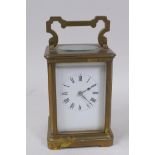 A brass cased carriage clock with striking movement, white enamel dial and Roman numerals, 13cm high