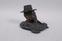A bronze inkwell after Bergman in the form of a man in a straw hat, lacks liner, stamped to base