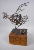 A metal work sculpture of a hen mounted on a wood plinth, signed to base Zoe Rubens, 32cm high