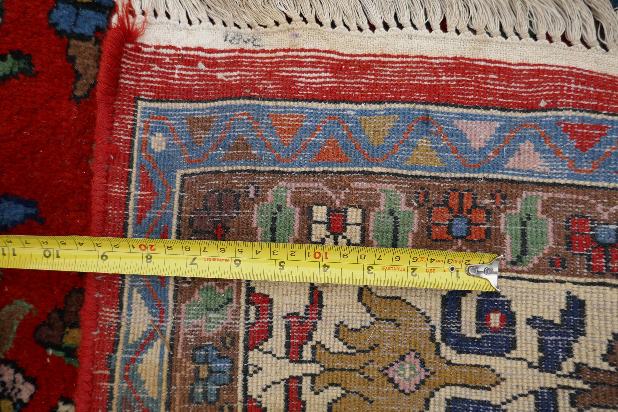 An eastern red ground hand woven wool carpet decorated with a multicolour flower and bird design, - Image 5 of 5
