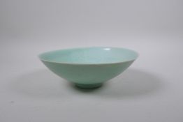 A Chinese Song style celadon glazed porcelain bowl with incised figural decoration, 21cm diameter